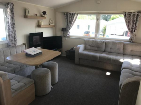 Stunning deluxe 3 bedroomed caravan with CH, DG and decking.